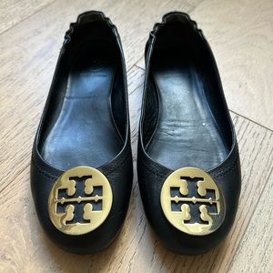 Classic black leather Tory Burch flats with gold buckle.